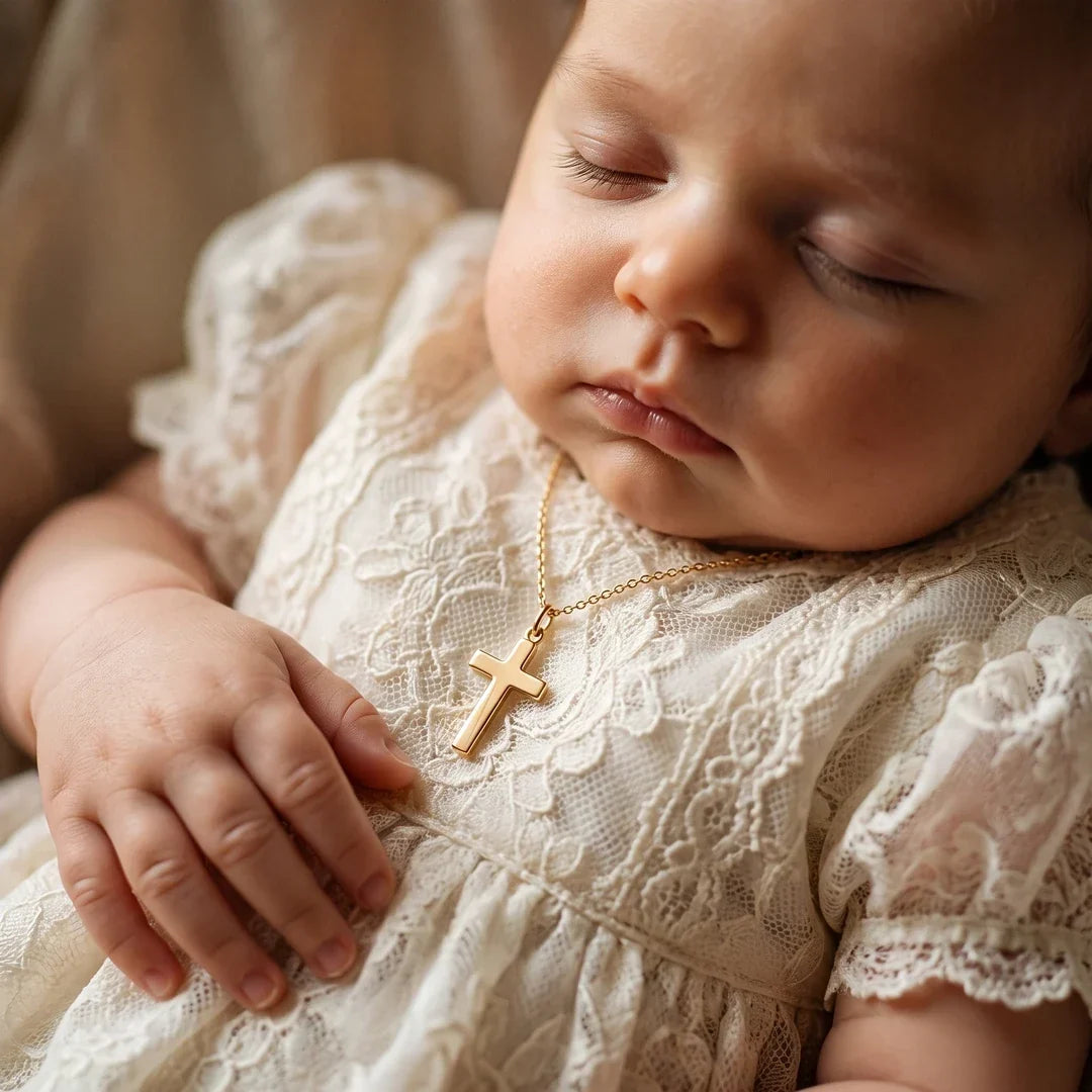 A baby wearing the Guardian Cross at their baptism